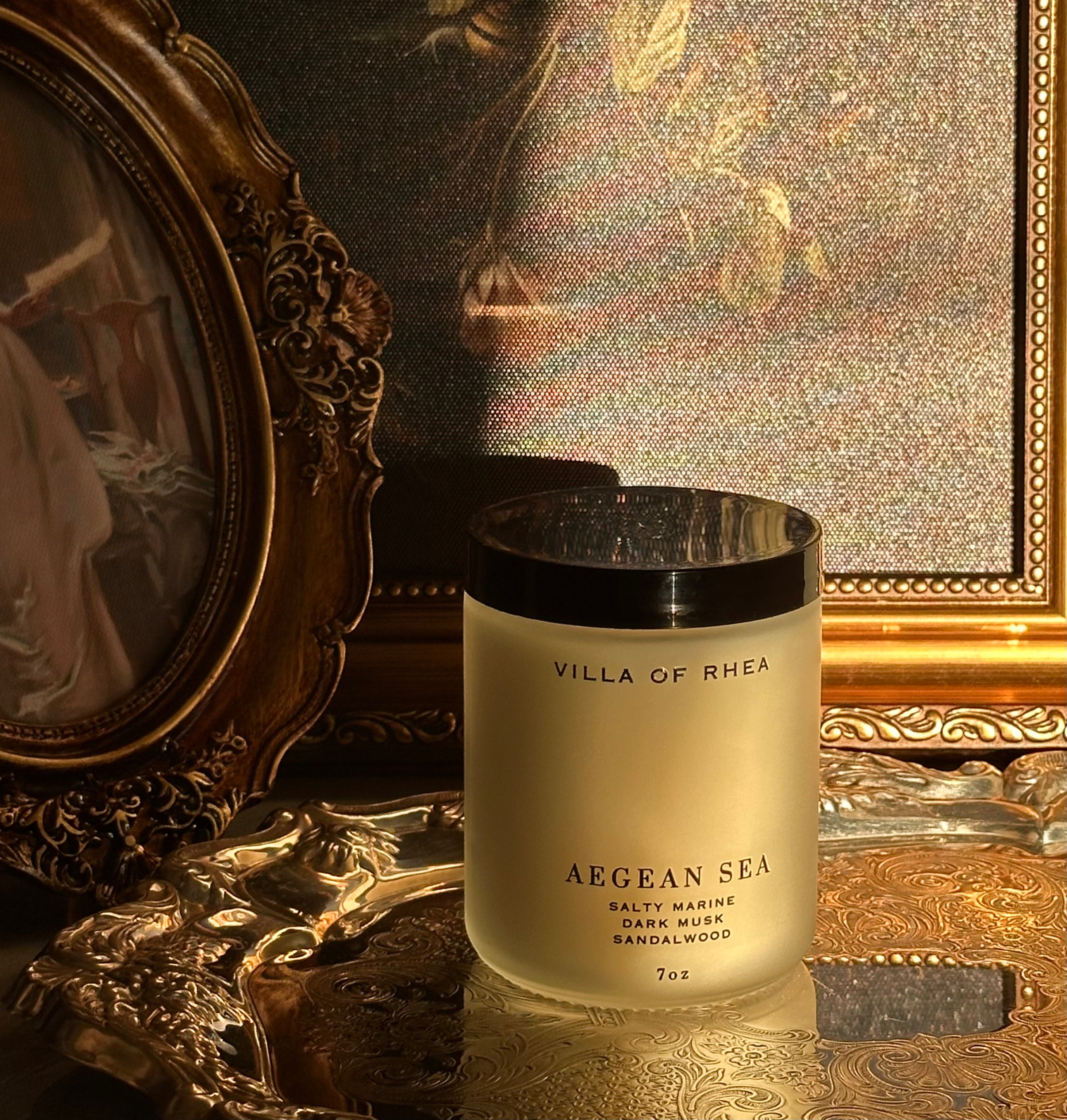 Villa of Rhea Aegean Sea candle on a reflective surface with decorative background. salty marine, dark musk, sandalwood scent. Vintage style. greek mythology inspired. luxurious soy wax candies. renaissance art. 