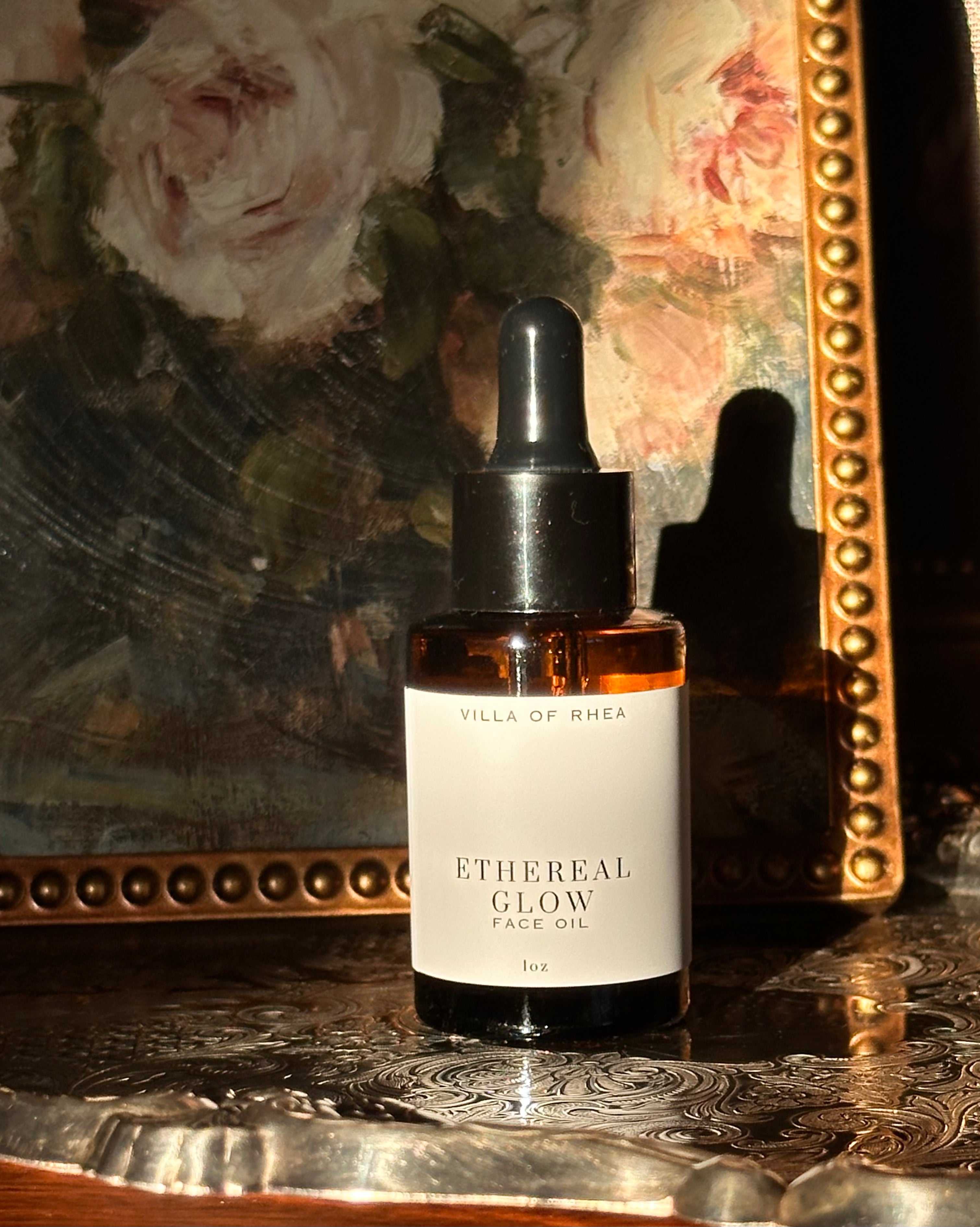 Ethereal Glow face oil bottle with dropper on a decorative surface. Vintage style. Greek Mythology Inspired. Luxury Face Oil. 