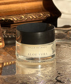 Jar of Villa of Rhea Aloe Vera lip balm on a decorative metal tray with a reflective background.Vintage style. Greek Mythology Inspired. Luxury lip balm. luxurious lip treatment