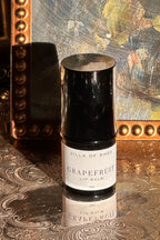 Villa of Rhea Grapefruit Lip Balm on a decorative surface with a textured background.Vintage style. Greek Mythology Inspired. Luxury lip balm. luxurious handmade lip balm