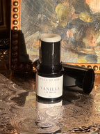 Villa of Rhea Grapefruit Lip Balm on a decorative surface with a textured background.Vintage style. Greek Mythology Inspired. Luxury lip balm. luxurious handmade lip balm