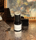 Villa of Rhea Grapefruit Lip Balm on a decorative surface with a textured background.Vintage style. Greek Mythology Inspired. Luxury lip balm. luxurious handmade lip balm